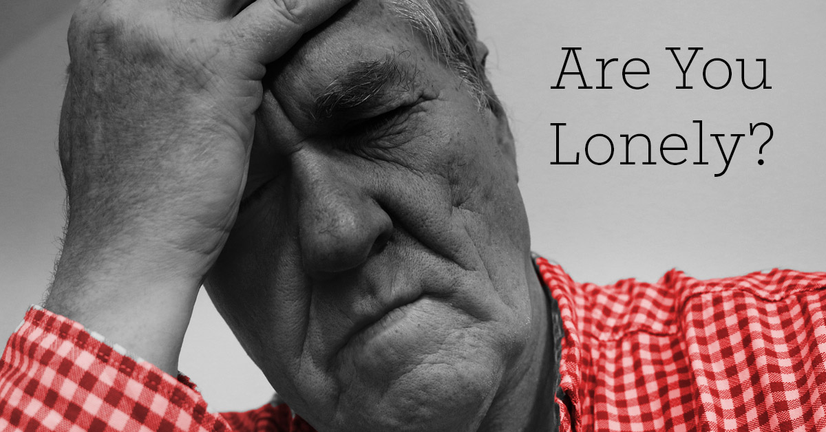Social Isolation Causes Health Effects for Seniors. Picture of an older caucasian male holding onto his head as if in frustration or sadness.